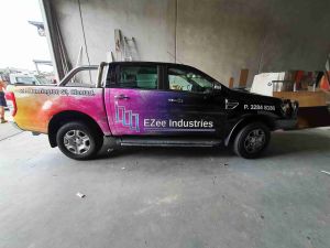 car with printed decals, EZee Industries logo