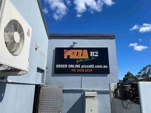 printed sign on wall, Pizza 82 sign